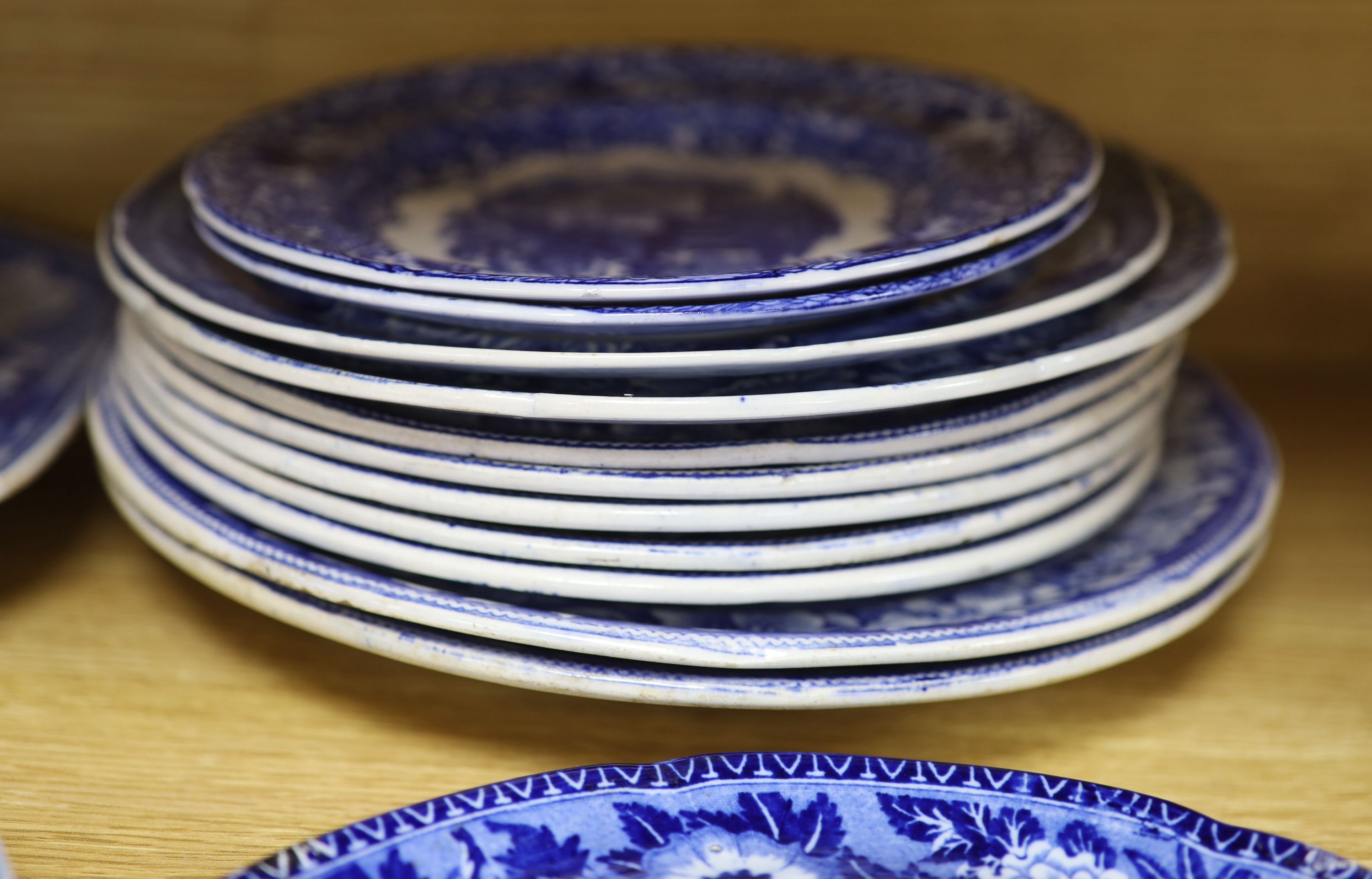 A quantity of 19th century blue and white pottery, including a Harewood House platter, 37cm, and a Spode Rome Tiber soup plate